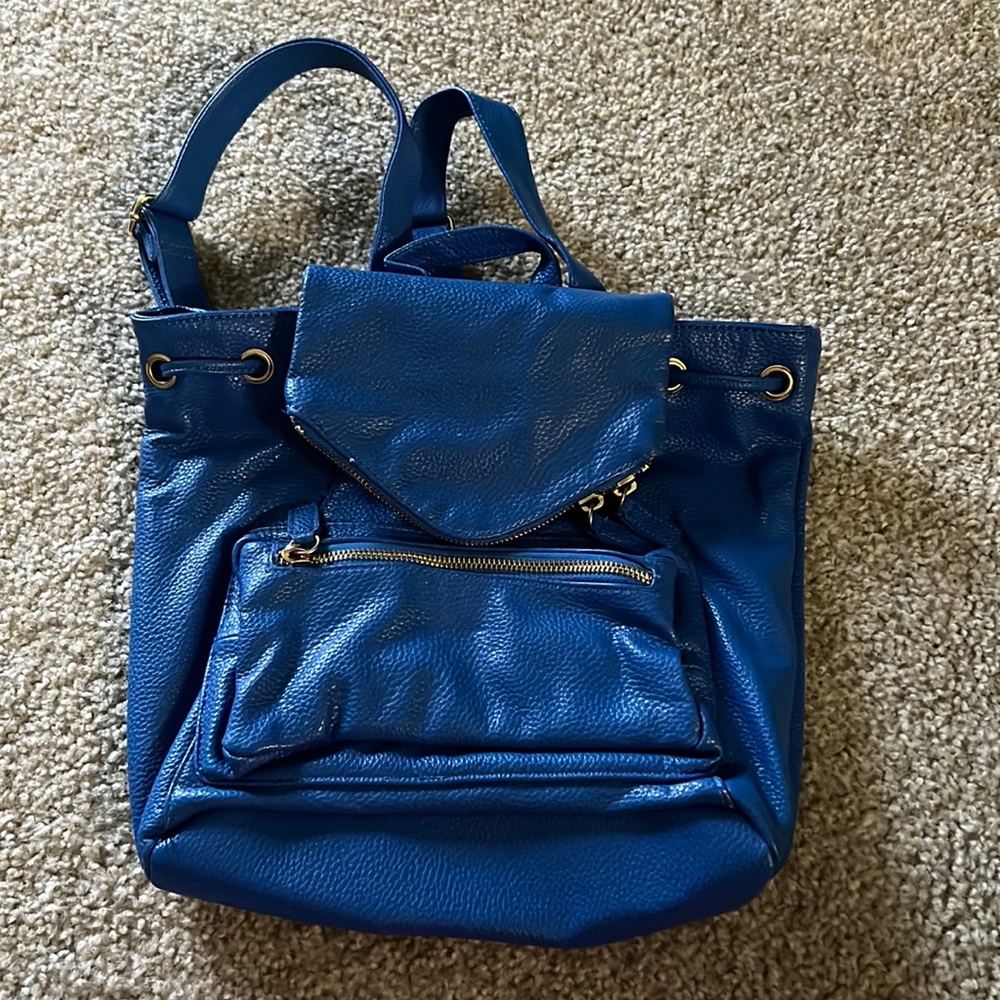 UO kimchi blue brand faux leather drag string backpack with multiple zip pockets